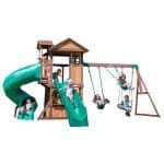 Kids playing on Tacoma Falls Swing Set with slide and swings in backyard.