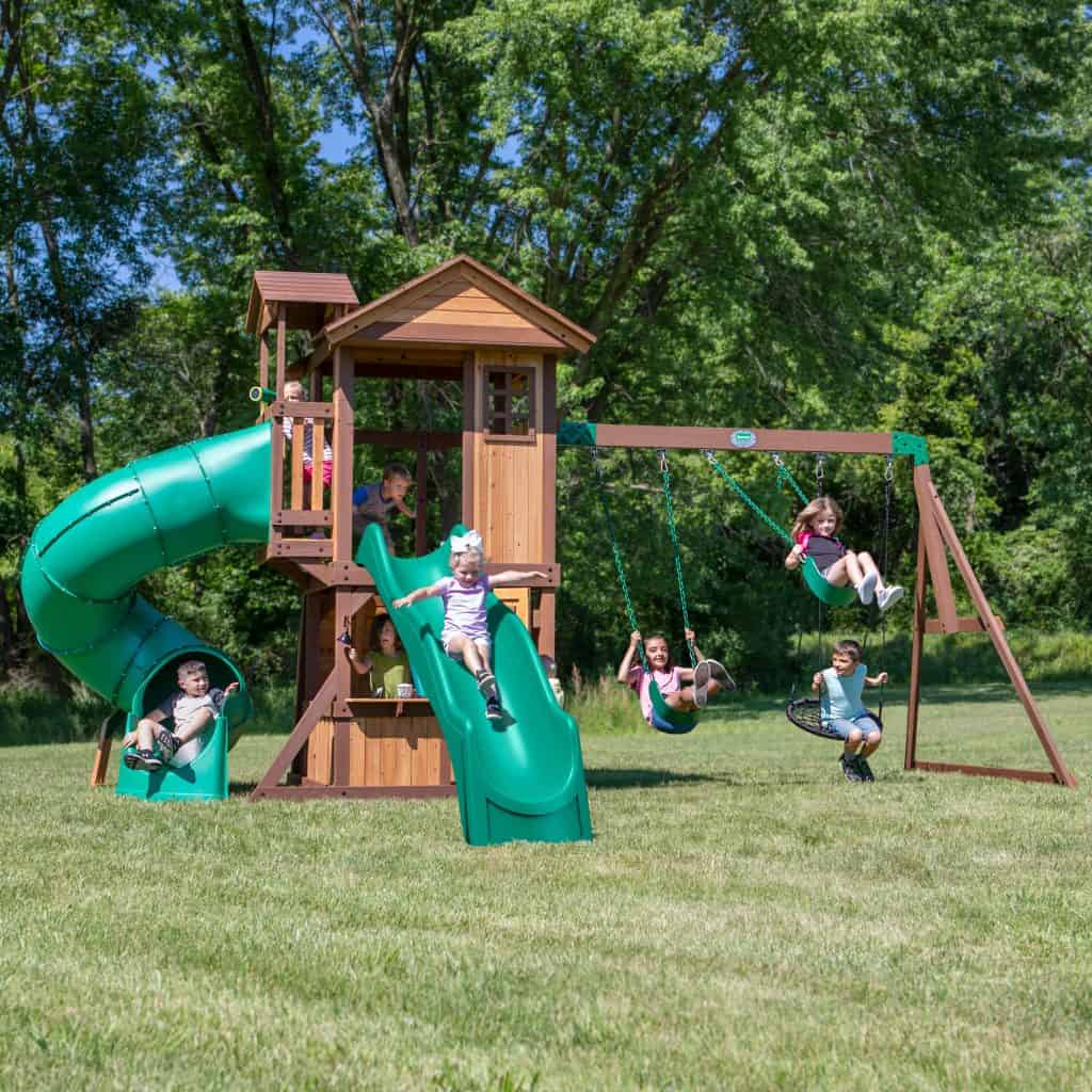 Children enjoying outdoor play on Tacoma Falls Swing Set in Texas backyard.