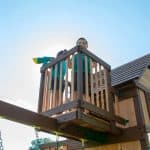 Children playing on Skyfort II outdoor playset with spiral slide in Texas.