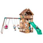Kids playing on Highlander Swing Set with slide and swings in backyard.