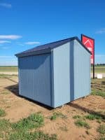 This image shows the exterior and rear view of a prefabricated wooden storage shed.