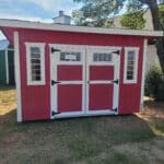 Red 8x12 studio shed featuring large front windows, white trim, and a clean modern design.