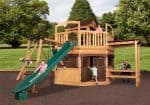 Titan Treehouse XL 13 swing set with double slides, climbing wall, and upper play fort in backyard setting.