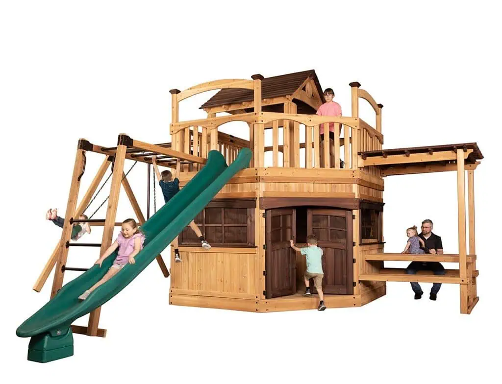 Titan Treehouse XL 13 swing set with wood-grain vinyl finish, featuring large fort, slides, and multiple swings.