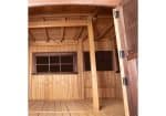 Interior view of Titan Treehouse XL 13 swing set play fort showing enclosed cabin area with windows and railing.