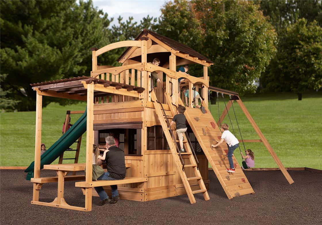 Right-side exterior view of Titan Treehouse XL 13 swing set with double slides, climbing wall, and tower fort.