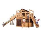 Titan Treehouse XL 14R swing set with wooden bridge, climbing wall, and tan tube slide.