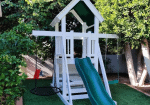 White and blue vinyl playset with an elevated tower, climbing ladder, and attached slide.