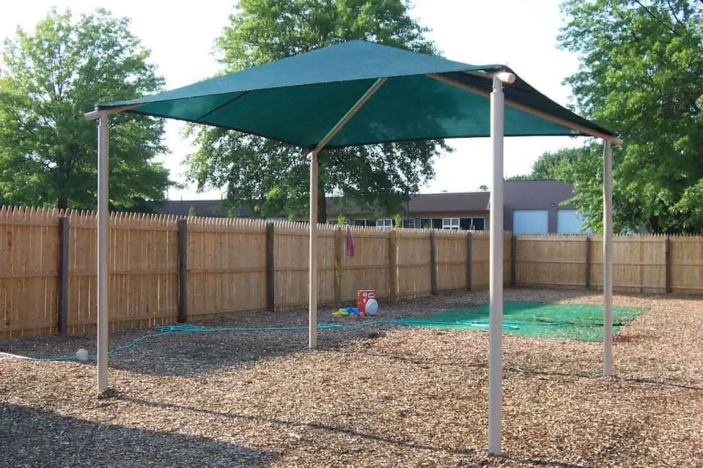Durable outdoor playground shade structure with metal poles and fabric canopy in Texas.