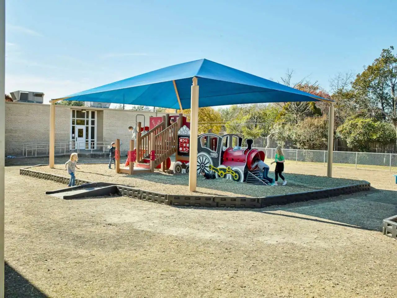 Large blue shade canopy over a children's playground in Texas.