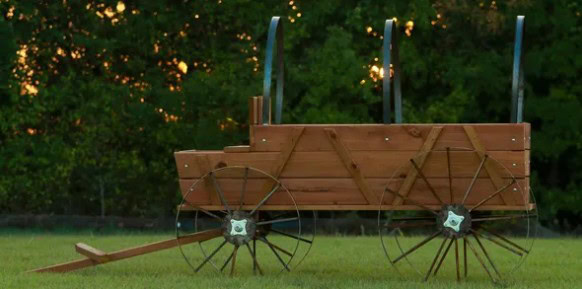 Wooden wagon with metal wheels for outdoor play in Texas.