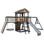 Outdoor wooden playset with slide, swings, and climbing wall for children.