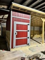Red and gray outdoor shed under construction in Texas.