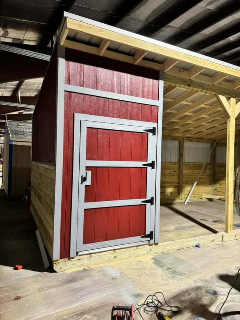 Red and gray outdoor shed under construction in Texas.