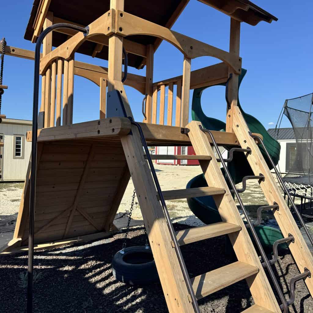 Wooden outdoor playset with slide and climbing stairs for kids in Texas.