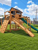 Wooden outdoor playset with slides and climbing wall in Texas backyard.