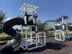 Outdoor playground with slide and climbing structure in North Texas.