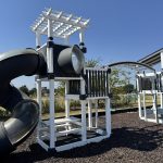 Outdoor playground with slide and climbing structure in North Texas.
