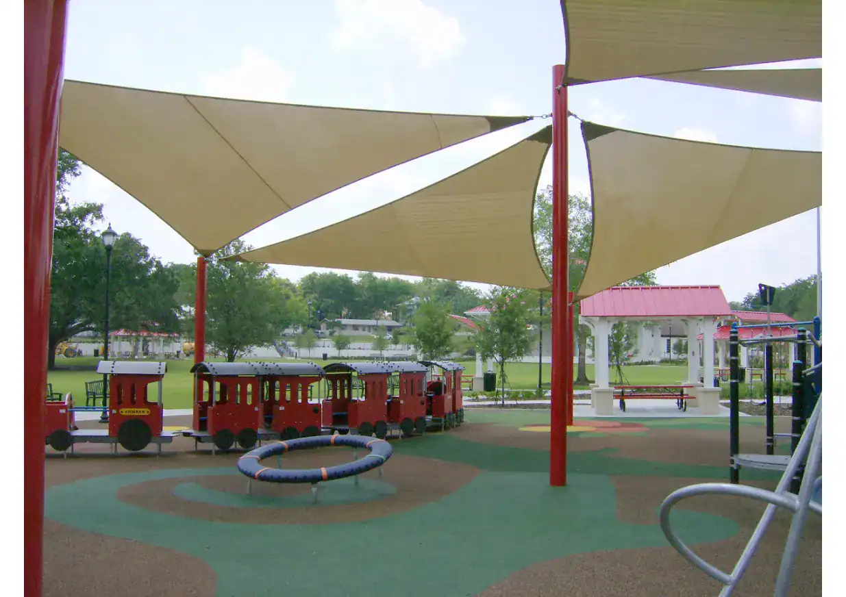 Multi-shade Fabric Shade Structure Colorful fabric shade sails over playground for kids in Texas.