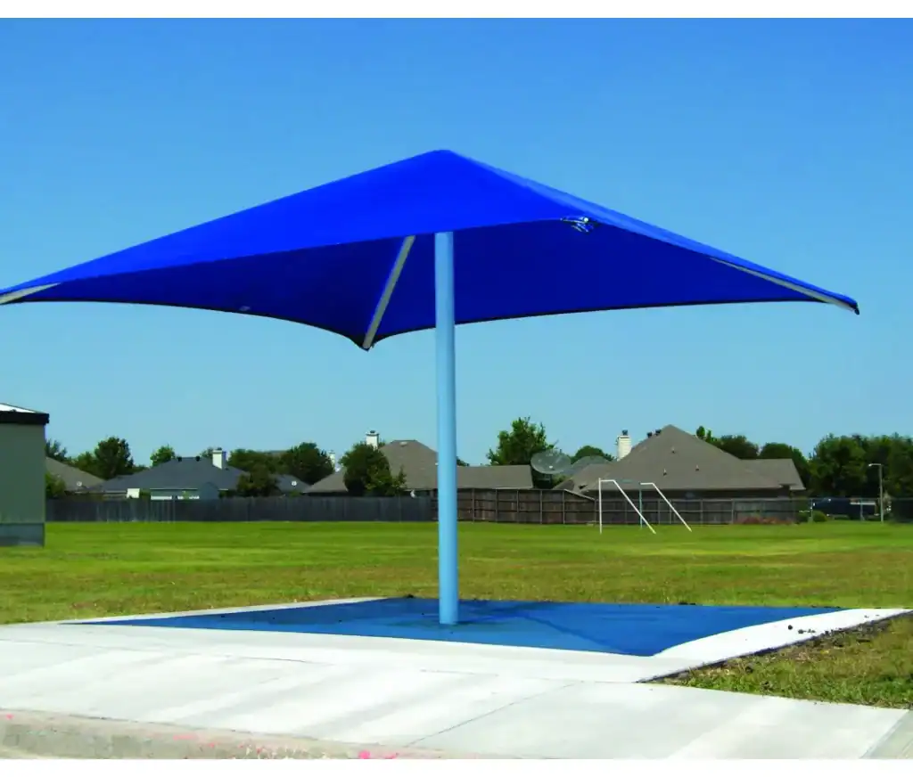 Blue square fabric shade over a concrete pad in a park setting.