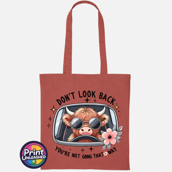 Don't Look Back Highland cow design on cotton tote bag orange rust - Print Unleashed