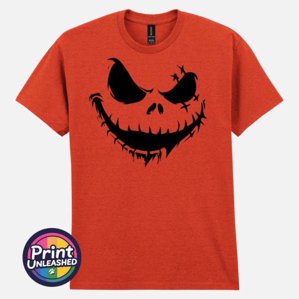 Stitched pumpkin face with uneven eyes and a crooked toothy grin on a Texas Orange unisex T-shirt - Print Unleashed