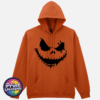 Stitched pumpkin face with uneven eyes and a crooked toothy grin on a Texas Orange Softstyle Hoodie - Print Unleashed