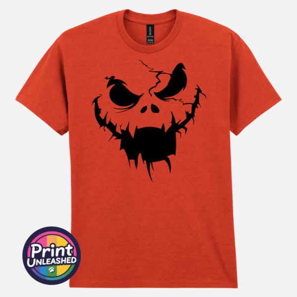Cracked pumpkin face with scowling eyes and a wide fanged mouth on a Texas Orange unisex T-shirt - Print Unleashed