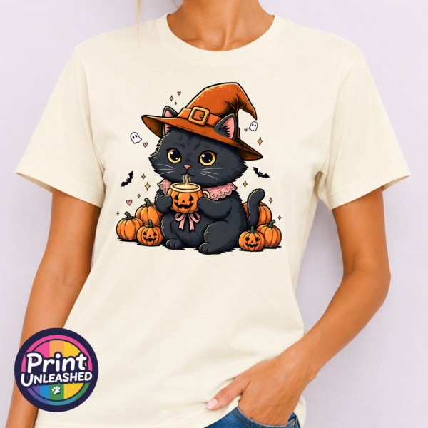 Black Cat model Cute black cat wearing an orange witch hat and pink collar, holding a steaming pumpkin mug among pumpkins, tiny ghosts and bats, printed on a unisex T-shirt model - Print Unleashed