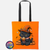 Cute black cat wearing an orange witch hat and pink collar, holding a steaming pumpkin mug among pumpkins, tiny ghosts and bats, printed on a tote bag in orange & black - Print Unleashed