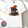 Cute black cat wearing an orange witch hat and pink collar, holding a steaming pumpkin mug among pumpkins, tiny ghosts and bats, printed on a unisex T-shirt white - Print Unleashed