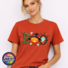 Halloween BOO design with tangled vines, a witch-hat pumpkin, ghosts and a spooky tree printed on a unisex T-shirt model - Print Unleashed