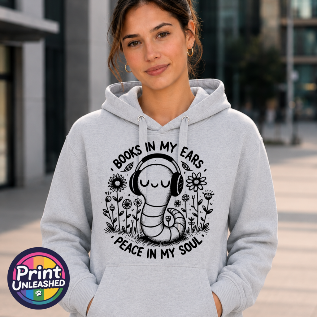 Smiling bookworm wearing headphones among flowers, with Books in My Ears Peace in My Soul wording, printed on an Everyday Hoodie heather grey model - Print Unleashed