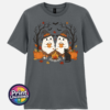 Two ghosts in witch hats holding orange mugs beside a campfire, with a black cat, pumpkins and autumn trees, printed on a unisex T-shirt charcoal - Print Unleashed
