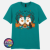 Two ghosts in witch hats holding orange mugs beside a campfire, with a black cat, pumpkins and autumn trees, printed on a unisex T-shirt jade - Print Unleashed