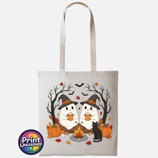 Camping Ghosts natural Two ghosts in witch hats holding orange mugs beside a campfire, with a black cat, pumpkins and autumn trees, printed on a tote bag natural - Print Unleashed