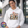 Three wide-eyed Christmas cows tangled in colourful lights, one wearing a Santa hat and another holding a candy cane, printed on a white unisex hoodie female model - Print Unleashed