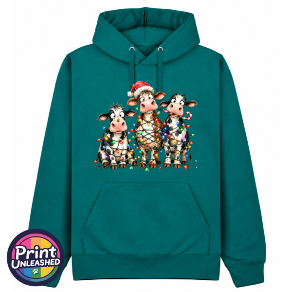 Three Christmas cows tangled in colourful lights, one wearing a Santa hat and another holding a candy cane, printed on a classic hoodie in pacific - Print Unleashed