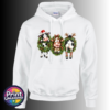 Three Christmas cows in festive wreaths, one wearing a Santa hat and another facing backwards with antlers and striped leg warmers, printed on a white unisex hoodie - Print Unleashed