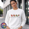 Four dachshunds dressed as Santa, a reindeer, an elf and a snowman above Dachshund Through the Snow wording, printed on a white unisex sweatshirt female model - Print Unleashed