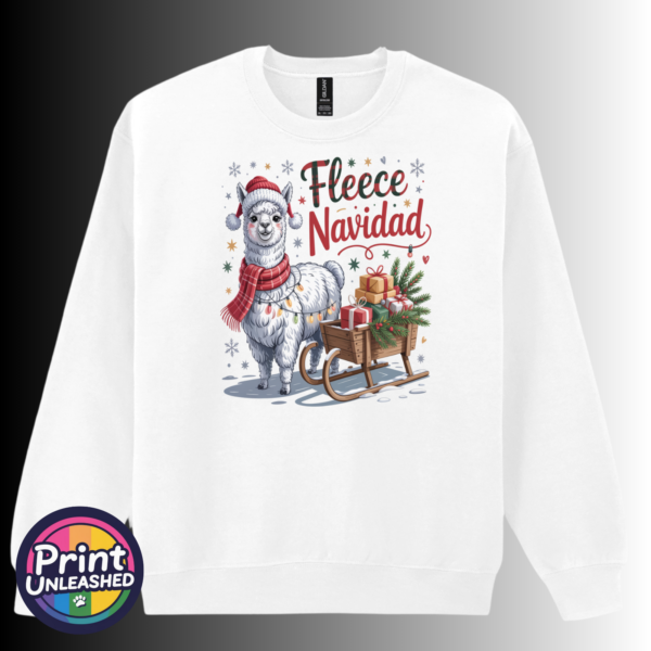 Christmas llama wearing a red knitted hat, tartan scarf and fairy lights beside a gift-filled sleigh, with Fleece Navidad wording on a white unisex sweatshirt - Print Unleashed