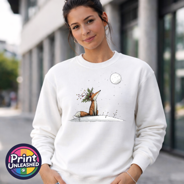Fox & Moon sweat model female Fox wearing a crown of holly and berries gazing at a full moon from a snowy hill, printed on a white unisex sweatshirt female model - Print Unleashed