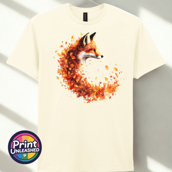 Fox in profile with its russet fur blending into a sweeping curve of orange, red and golden autumn leaves printed on a unisex T-shirt off white - Print Unleashed