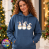 Classic Hoodie featuring three Christmas gonks sitting on cream speckled cups, wearing grey festive hats with red details and holding sweet treats, model image - Print Unleashed