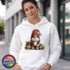 Christmas gonk in a red snowflake-patterned hat holding hot chocolate piled with marshmallows, surrounded by gingerbread stars and holly, printed on a white unisex hoodie female model - Print Unleashed
