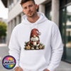 Christmas gonk in a red snowflake-patterned hat holding hot chocolate piled with marshmallows, surrounded by gingerbread stars and holly, printed on a white unisex hoodie male model - Print Unleashed