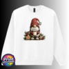 Christmas gonk in a red snowflake-patterned hat holding hot chocolate piled with marshmallows, surrounded by gingerbread stars and holly, printed on a white unisex sweatshirt - Print Unleashed