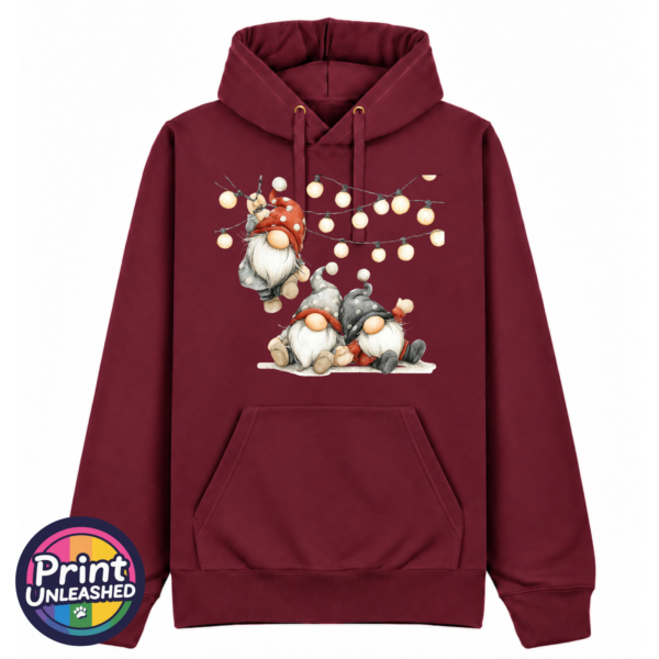 Classic Hoodie in pepper red featuring three Christmas gonks in red and grey spotted hats, with one hanging from strings of warm glowing lights above two seated companions - Print Unleashed