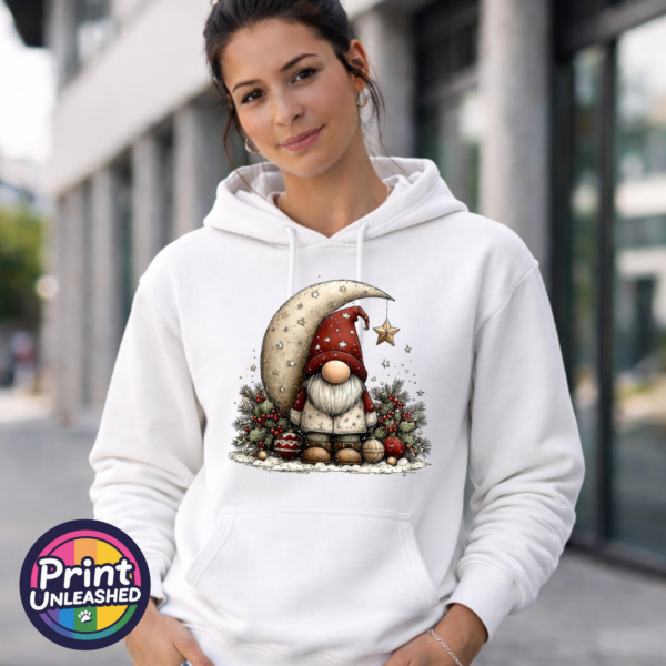 Gonk Moon hoodie model female Christmas gonk in a red star-patterned hat beside a cream crescent moon and hanging gold star, with holly and baubles, printed on a white unisex hoodie female model - Print Unleashed