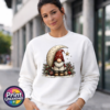 Christmas gonk in a red star-patterned hat beside a cream crescent moon and hanging gold star, with holly and baubles, printed on a white unisex sweatshirt female model - Print Unleashed